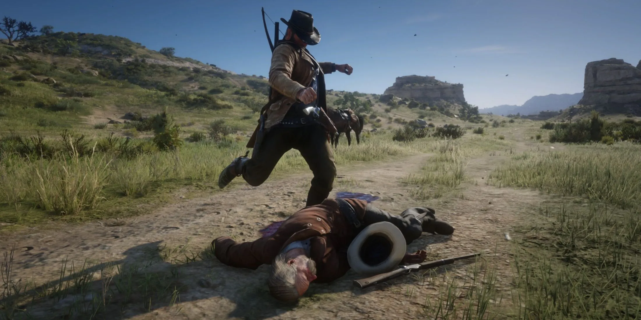 آرتور مورگان از Red Dead Redemption 2 در حال لگد زدن به بدن قانونگذاران در Red Dead Redemption 2