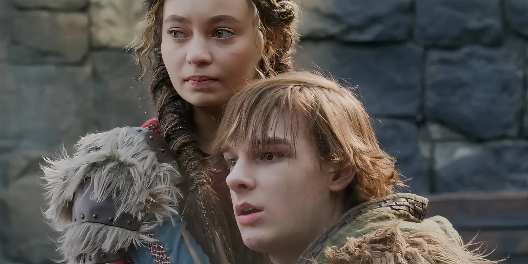 Nico Parker as Astrid looking intense next to Mason Thames as Hiccup looking worried in How to Train Your Dragon